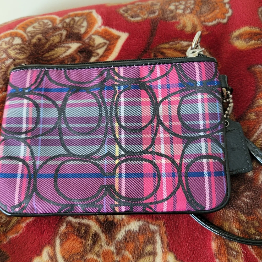 Coach Poppy tartan wristlet in pink and purple.